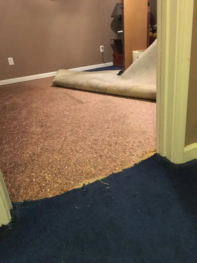 Carpet pad removal revealing water damage during Drying & Dehumidification in Crossville